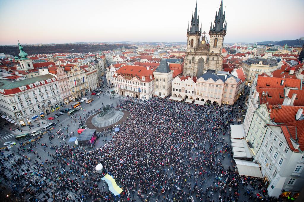 A crowd of thousands of people in a square seen from above